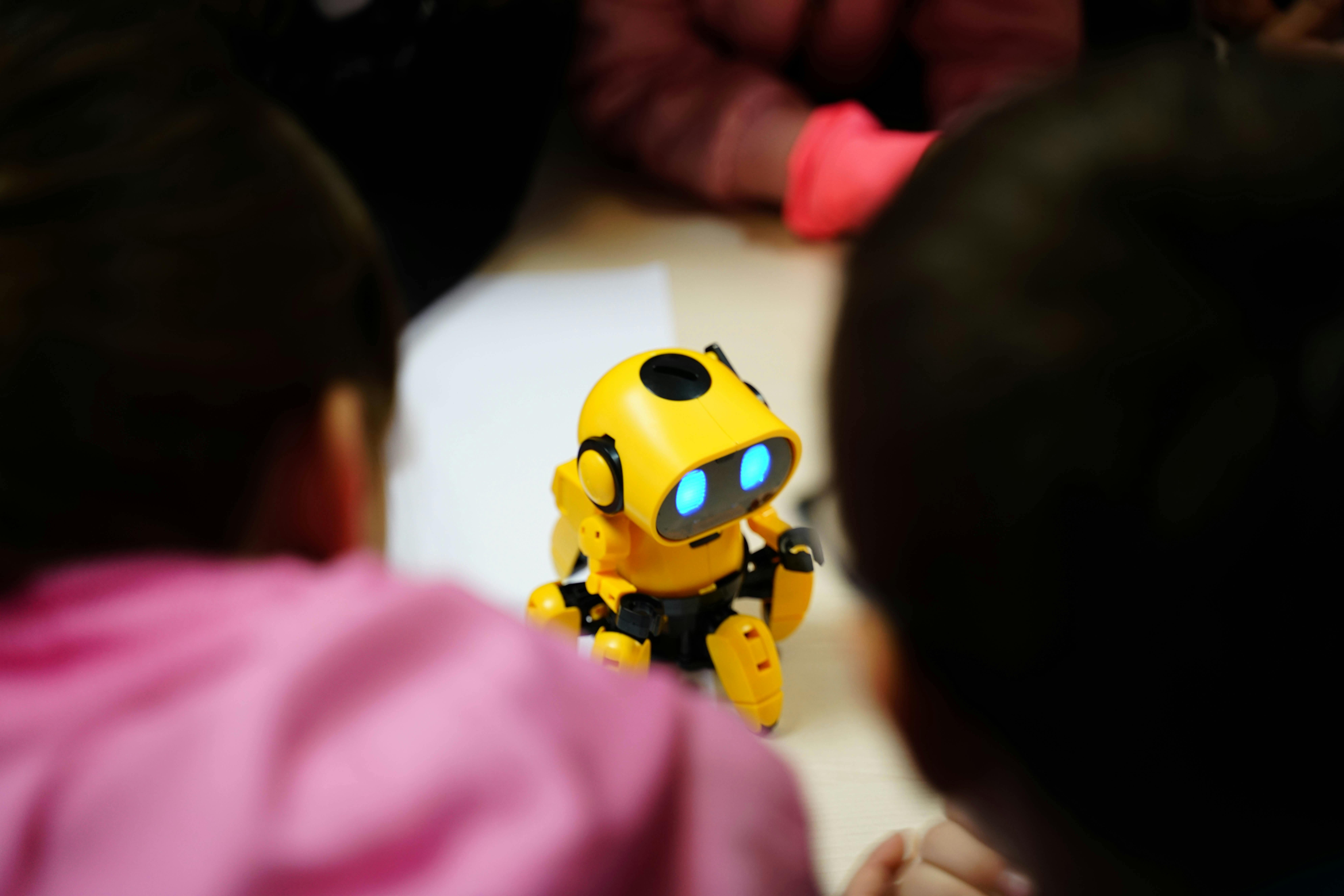 Young child exploring beginner robotics on a floor-based grid with hands-on materials